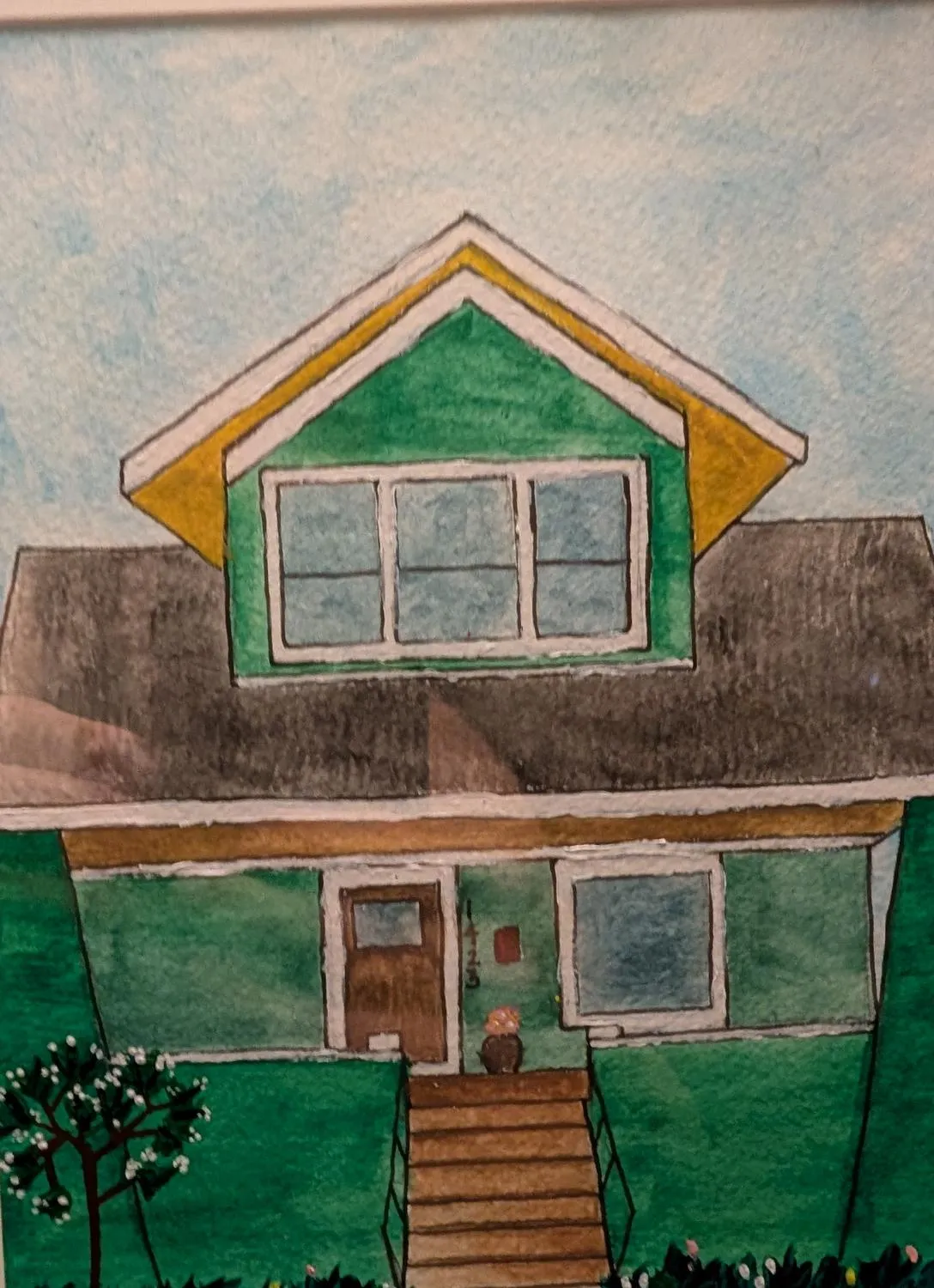 A watercolor painting of a house, framed.