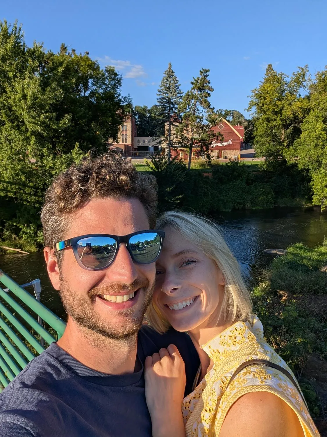 Sean and Ashley at a brewery, glasses raised.